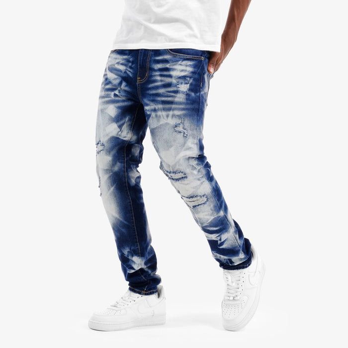 Copper Rivet Rip Heavy Bleach Wash Denim jeans with distressed details and a relaxed fit, shown in a close-up view.