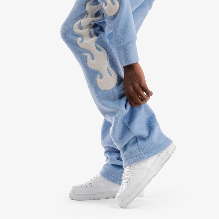 Light blue Copper Rivet Saints Mohair Pearl Stacked Sweat Pants with ribbed cuffs and relaxed fit, showcasing stylish casual wear.
