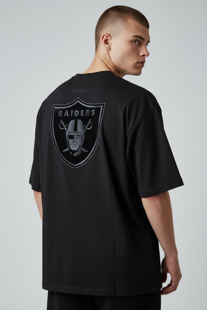 Black Pro Standard Las Vegas Raiders 'Blackout' drop shoulder T-shirt with Raiders logo, casual athletic style.