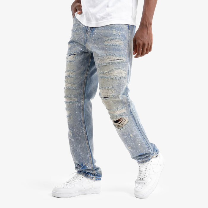 VOYAGE STUDIO Stone On Repair full rhinestone straight fit denim jeans in blue with distressed details and repair accents.