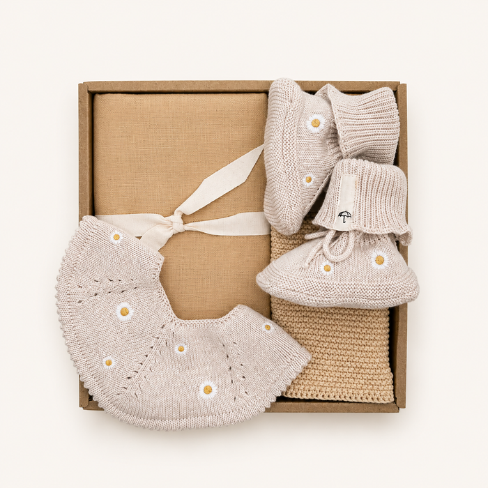 Luxury Baby Gift Box with knitted Daisy baby bib, baby booties, muslin cloth and organic cotton washcloth by Saga Copenhagen.