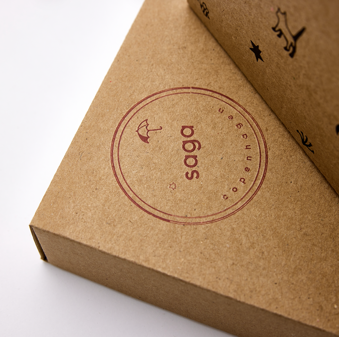 Saga Copenhagen gift box in kraft paper with embossed logo and premium gift packaging design.