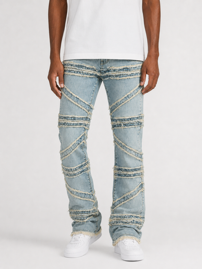 FWRD Crossover Stacked Denim jeans in Ice Tint with layered, distressed design and stacked detailing on the legs.